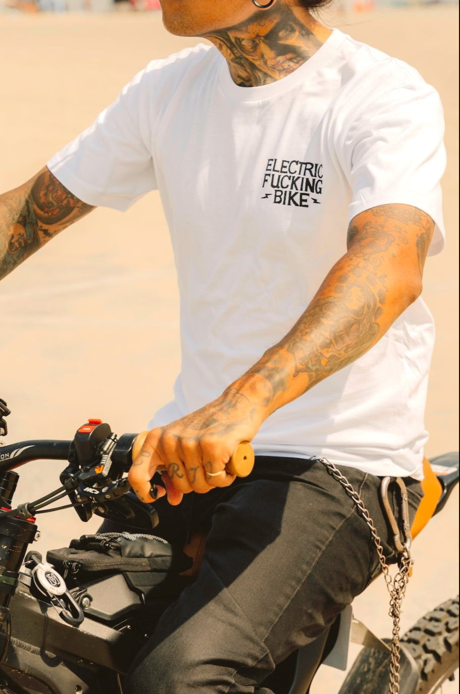 Person wearing an electric bike white shirt  sitting on an electric motorcycle.