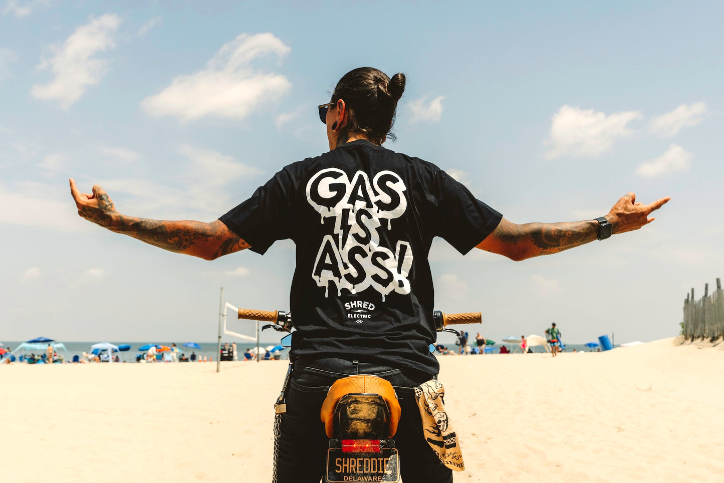 Gas Is Ass black t-shirt back view hands stretched on bike