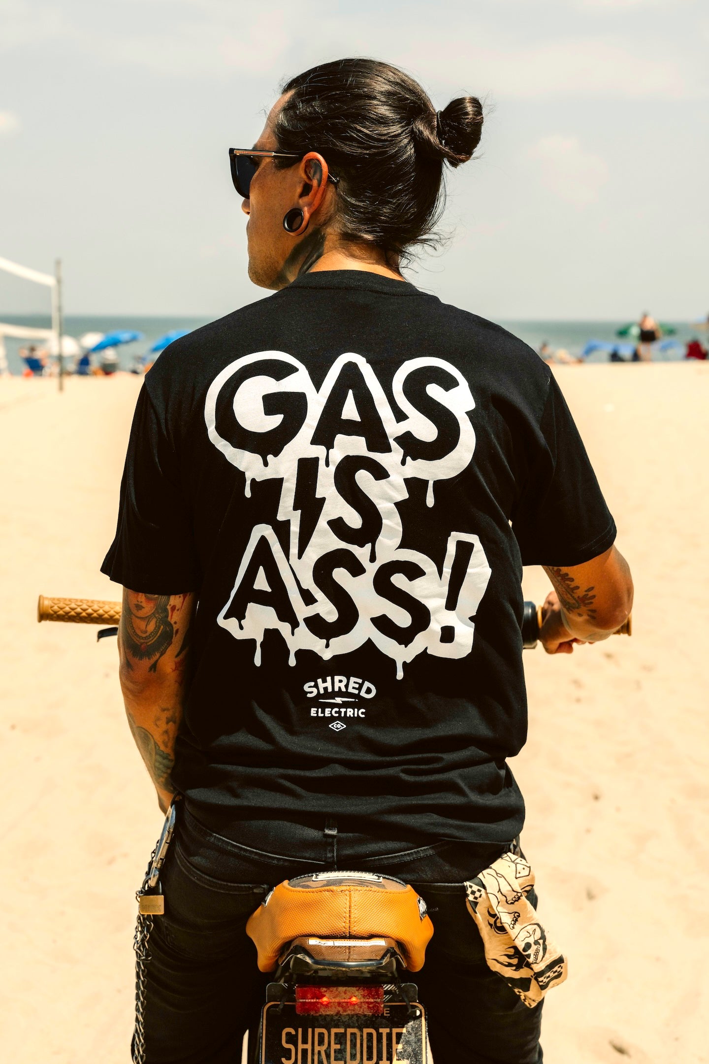 Gas Is Ass black t-shirt back view on electric dirt bike 